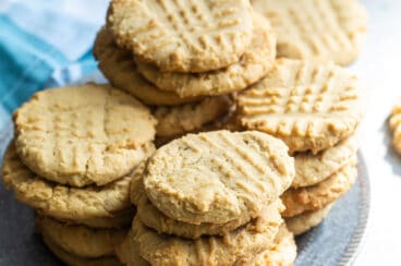 Peanut butter cookies stacked on a blue plate.