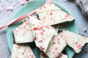 Peppermint bark on a teal plate.