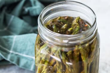Pickled asparagus in a mason jar.