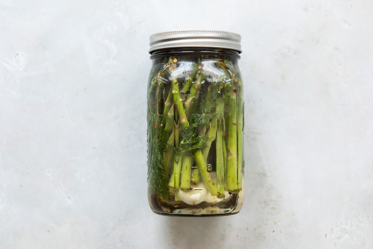 Pickled asparagus in a jar.