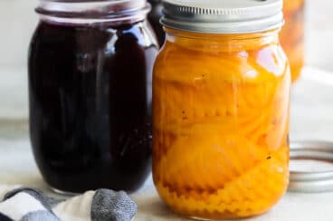 Pickled beets in two mason jars.