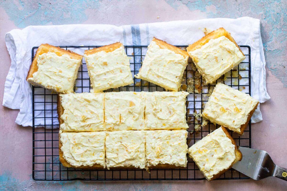 Squares of Pig Pickin' Cake on a black cooling rack.