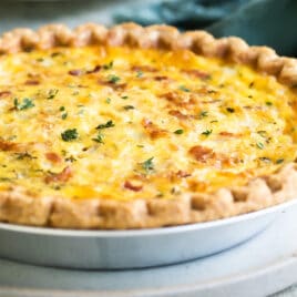 A quiche Lorraine in a silver pie pan.