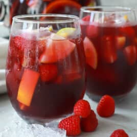 A pitcher and two glasses of red sangria.