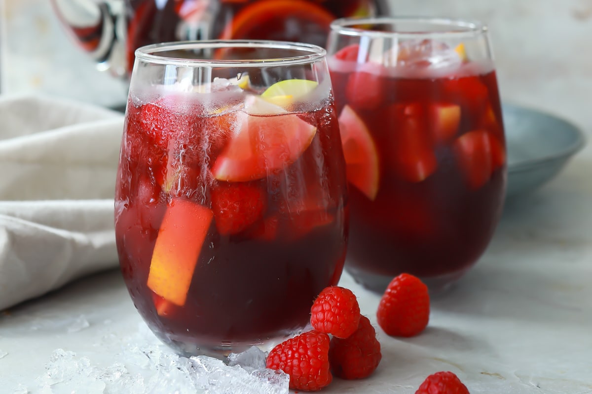 A pitcher and two glasses of red sangria.