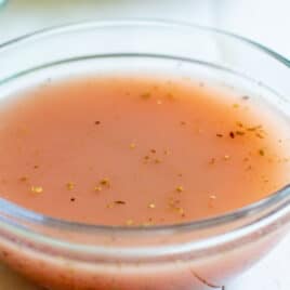Red wine vinaigrette in a clear glass bowl.