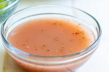 Red wine vinaigrette in a clear glass bowl.
