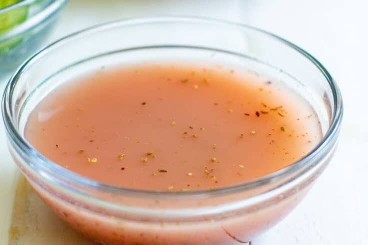 Red wine vinaigrette in a clear glass bowl.