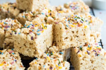 A cooling rack with a stack of rice krispie treats.