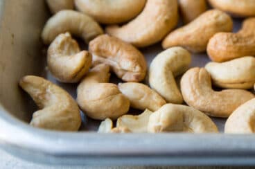 Roasted cashews on a baking sheet.