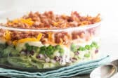 Seven layer salad in a glass dish.