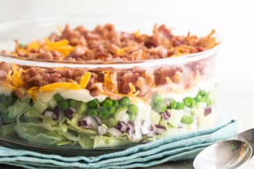 Seven layer salad in a glass dish.