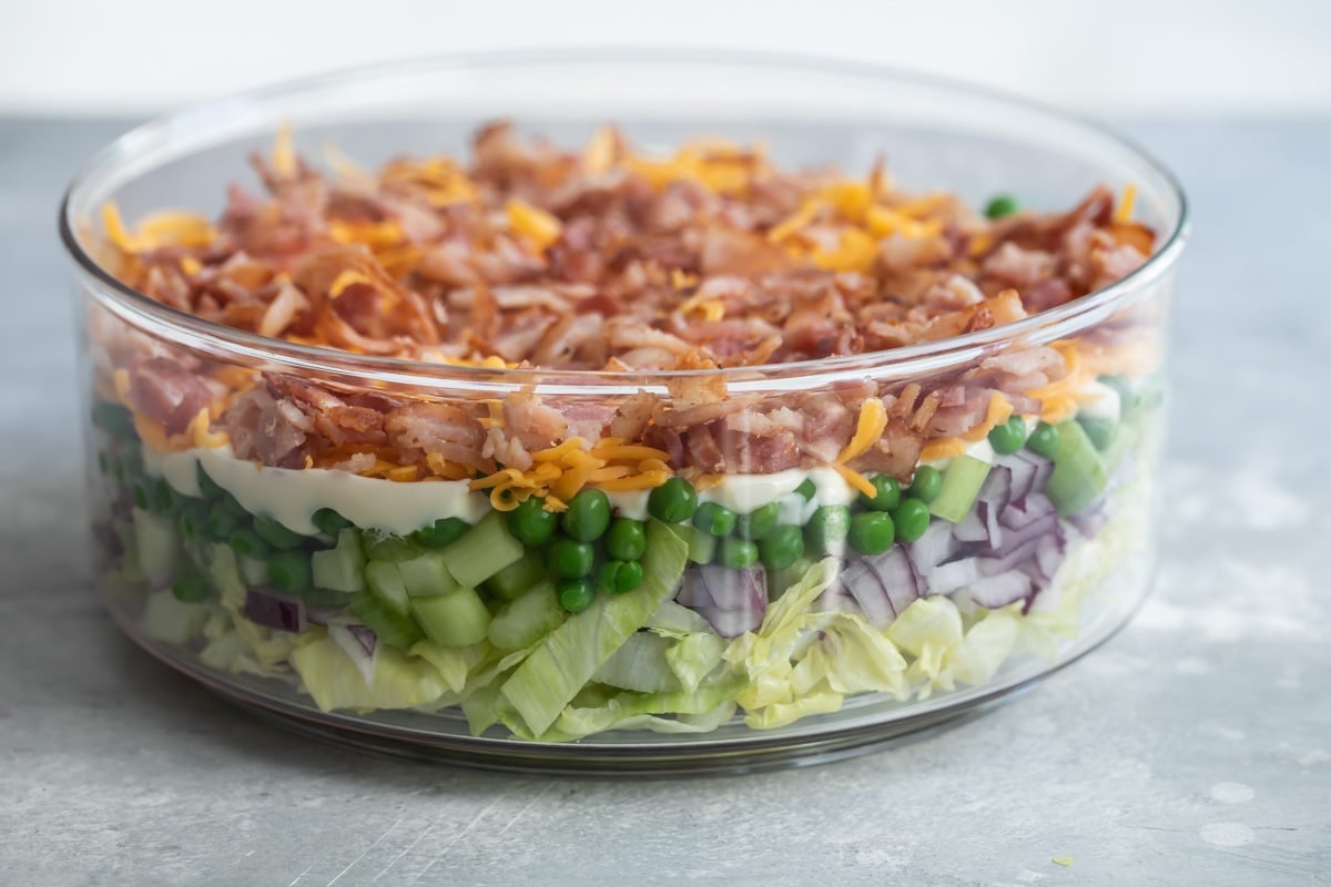 Seven layer salad in a glass dish.
