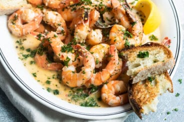 Shrimp scampi on a white platter.