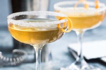 Sidecar cocktails in two clear stemmed glasses.