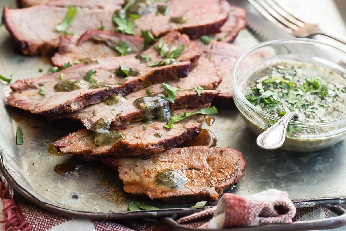 Slices of smoked tri tip on a serving platter.