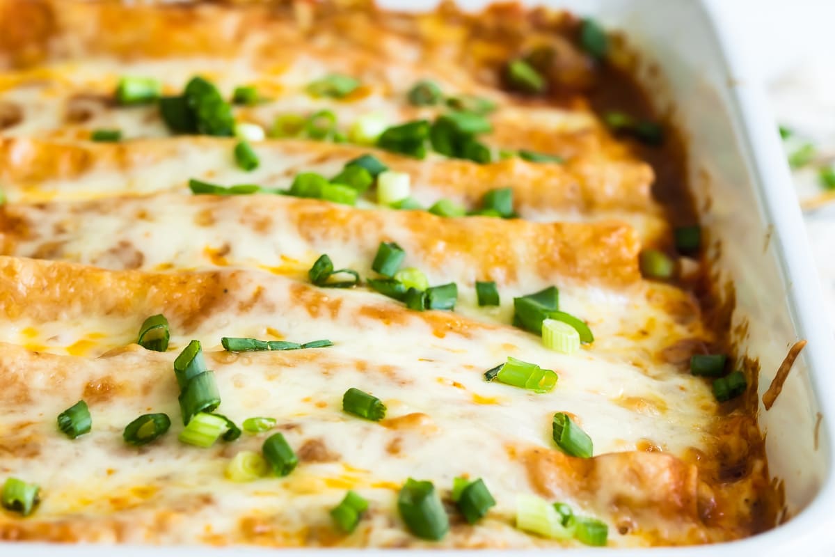 Sour cream and chicken enchiladas in a baking dish.