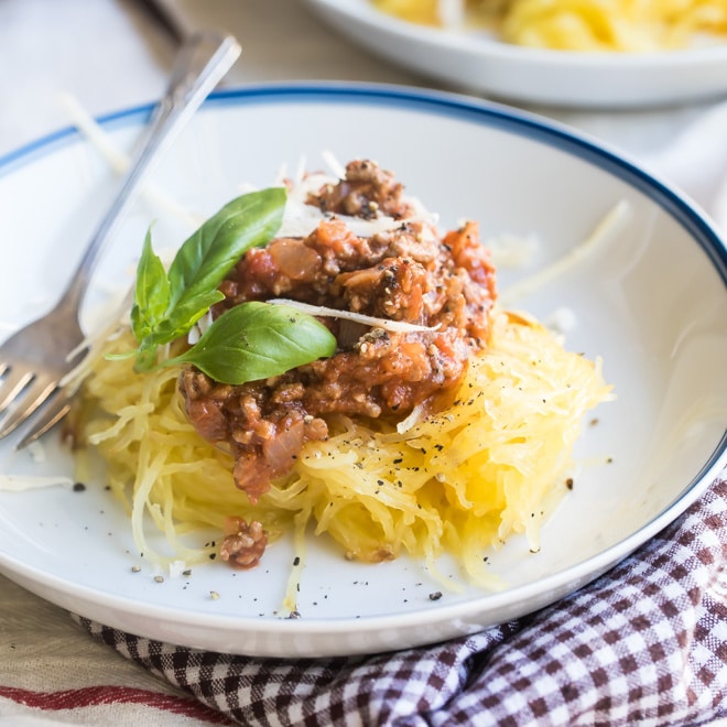 Spaghetti squash with homemade meat sauce on a white plate.