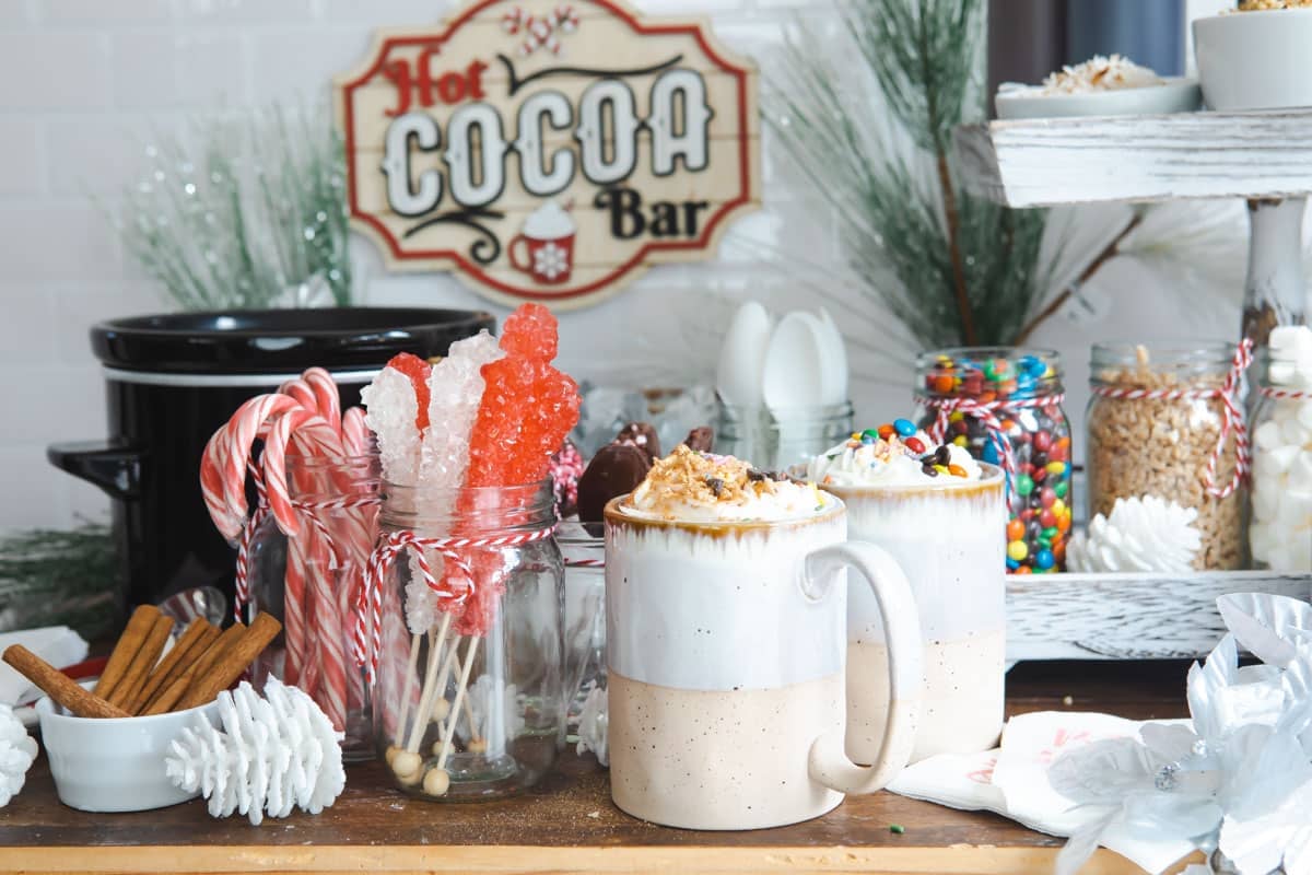 Two cups of hot chocolate at a hot cocoa bar.
