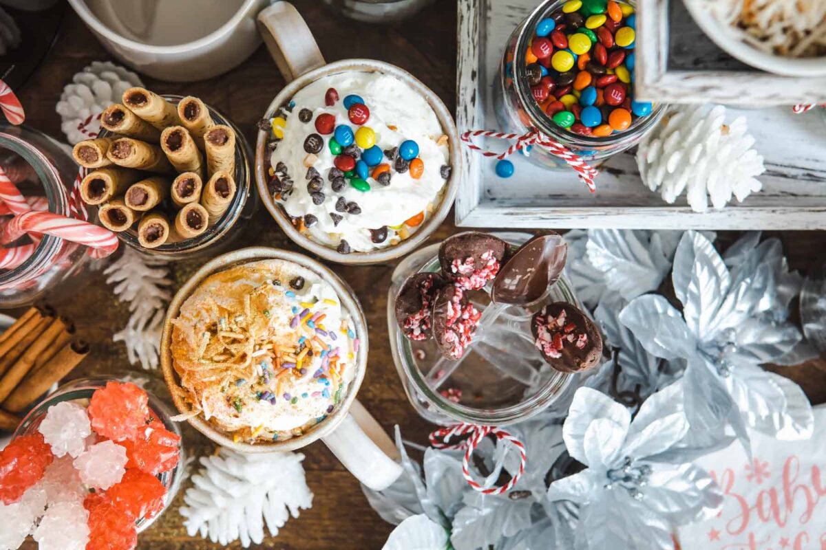 Two cups of hot chocolate at a hot cocoa bar.