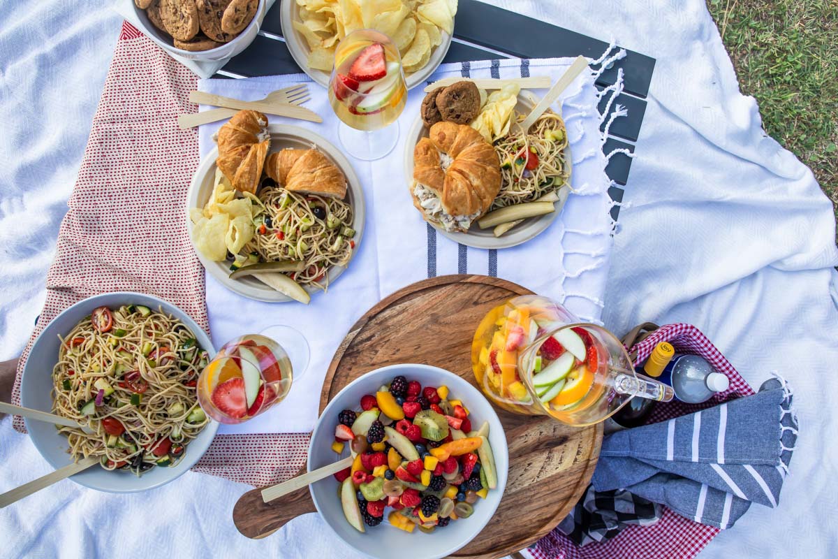 A set up of a picnic foods in a park.