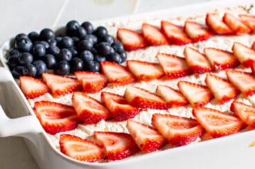 Strawberry Jello Poke Cake decorated like an American Flag.