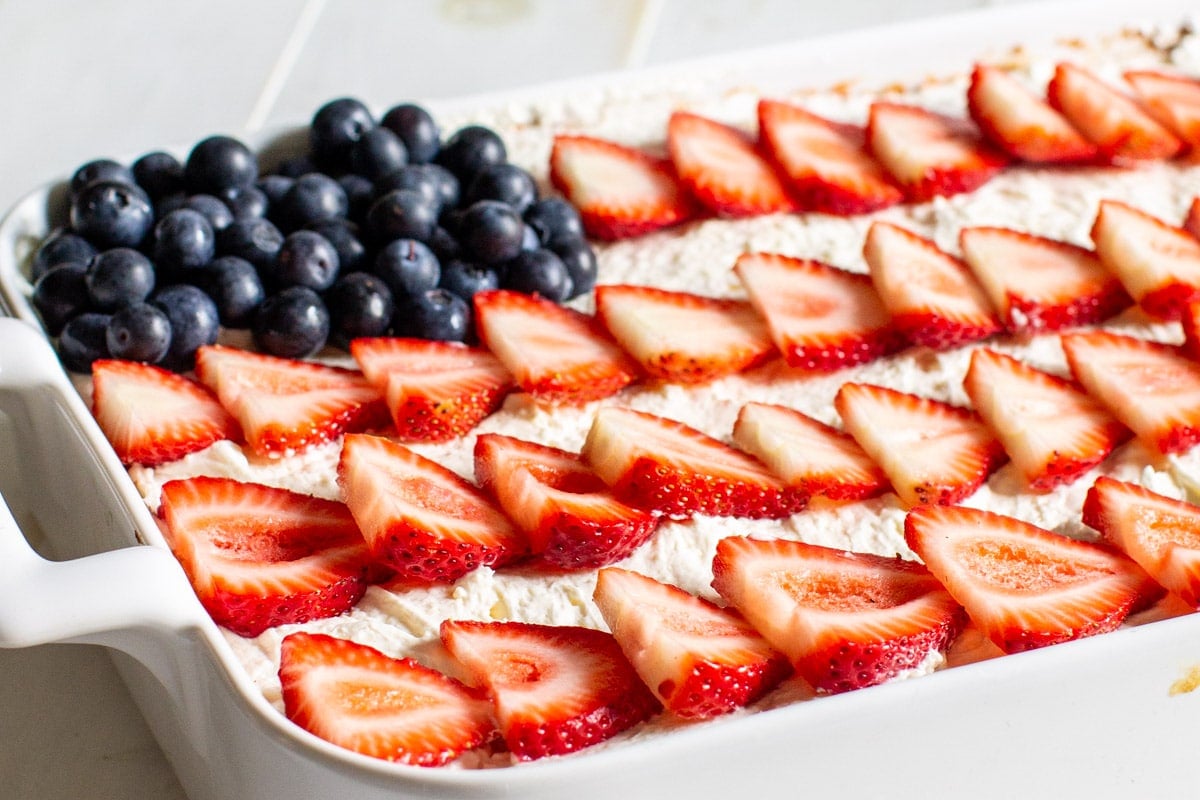 Strawberry Jello Poke Cake decorated like an American Flag.