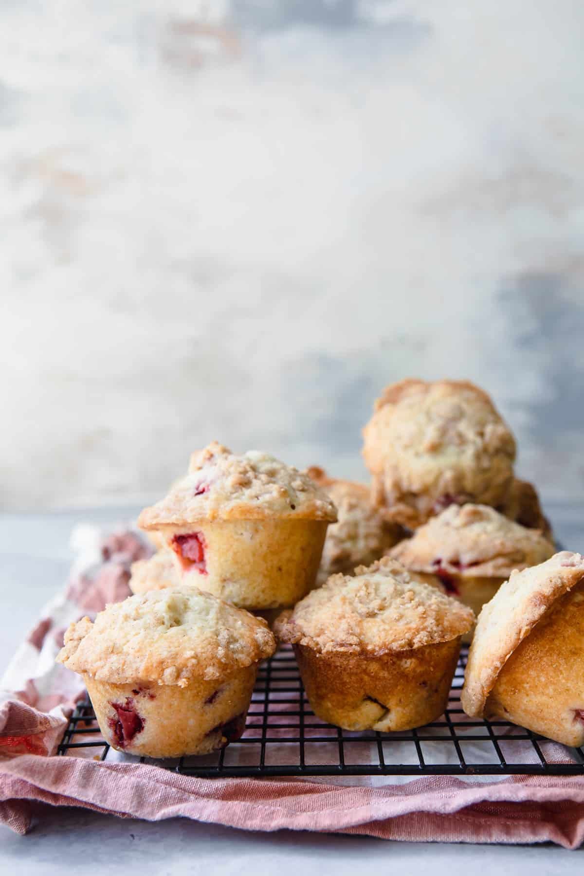 A rack filled with strawberry rhubarb muffins.