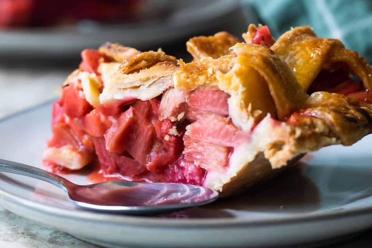 A slice of strawberry rhubarb pie on a plate.