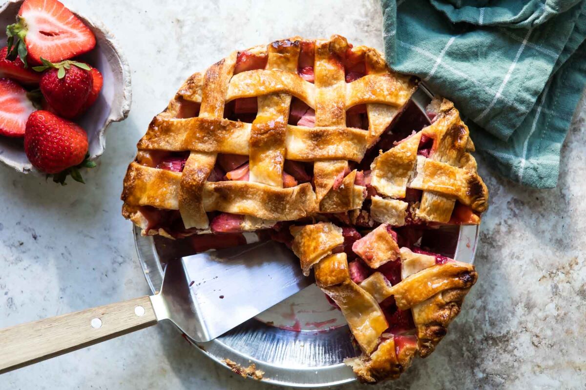 Strawberry rhubarb pie in a silver pie pan.
