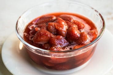 A bowl of strawberry topping.