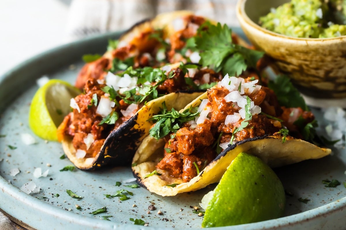 Tacos al Pastor on a blue plate.