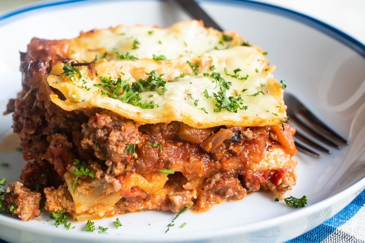 The best make ahead lasagna slice on a white plate.