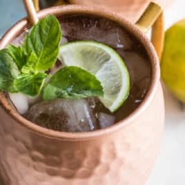 The best Moscow mule in a copper mug with a lime.