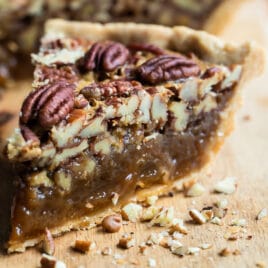 Slices of pecan pie on a board.