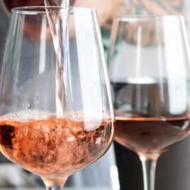 Rosé wine being poured into a glass.