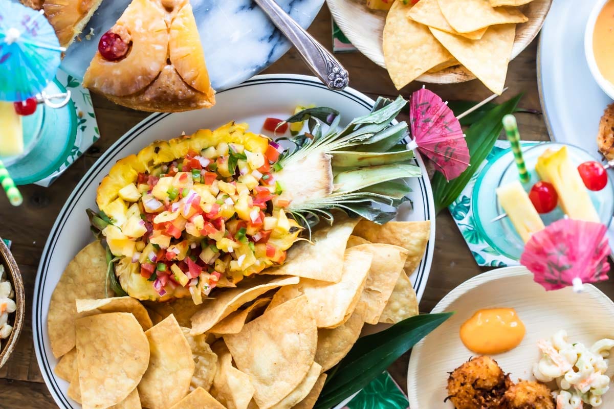 Pineapple salsa in a hollowed out pineapple on a platter.