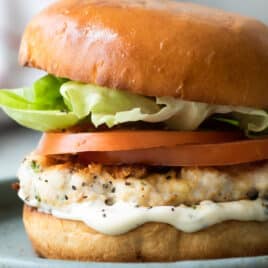 A turkey burger on a blue plate.