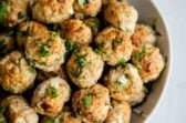 Turkey meatballs in a white serving bowl.