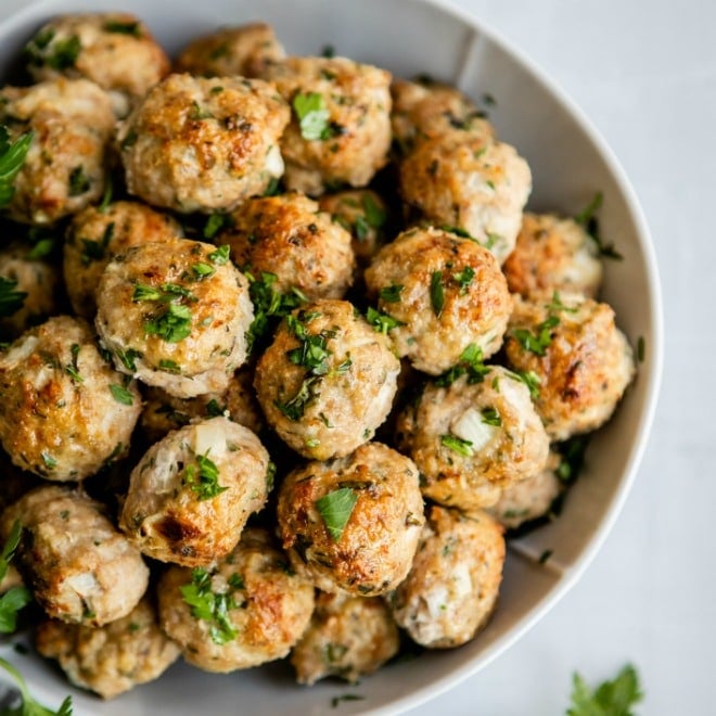 Turkey meatballs in a white serving bowl.