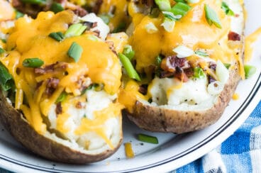 Twice baked potatoes on a white platter.