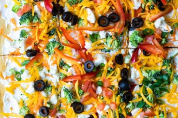 A veggie pizza cut into squares.