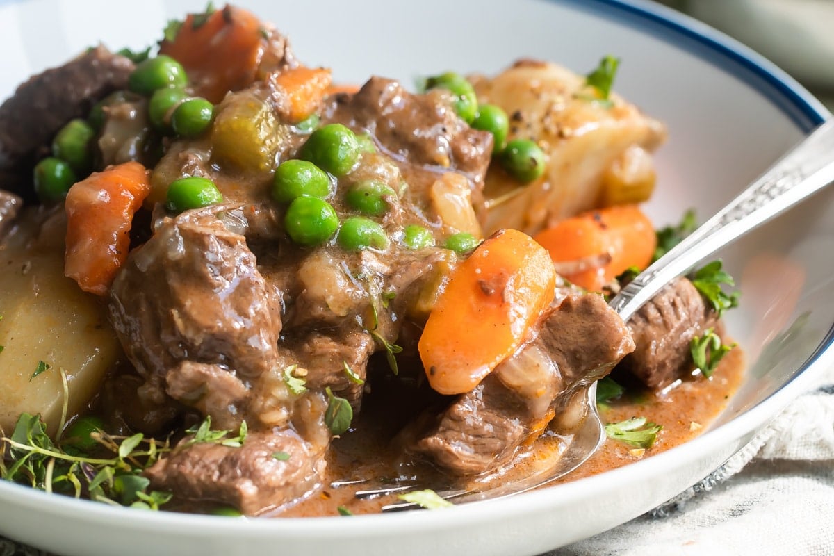 Venison stew in a white bowl.