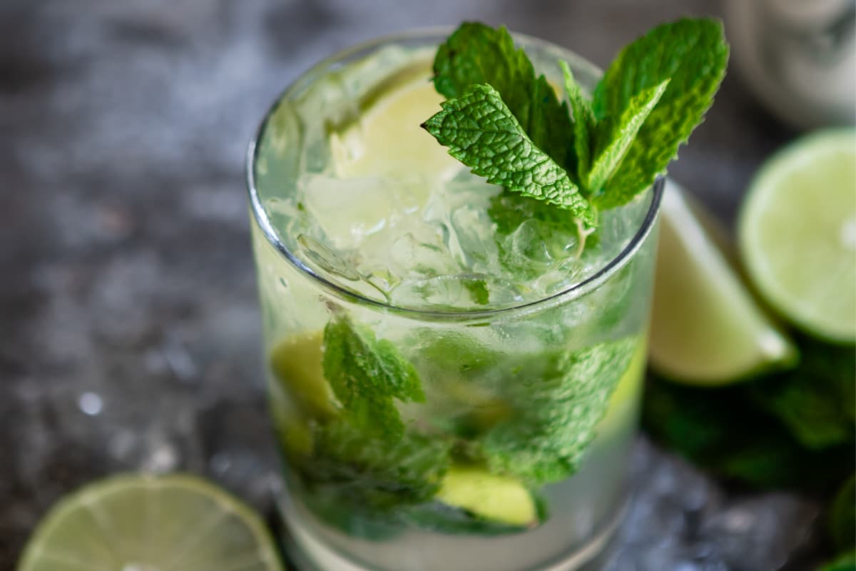A virgin mojito mocktail in a clear glass.