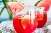 Watermelon agua fresca in glasses with wedges of watermelon.