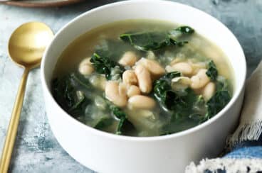 White bean and kale soup in a bowl.