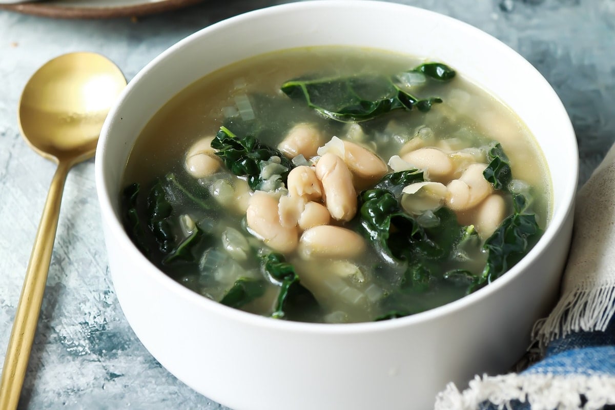 White bean and kale soup in a bowl.