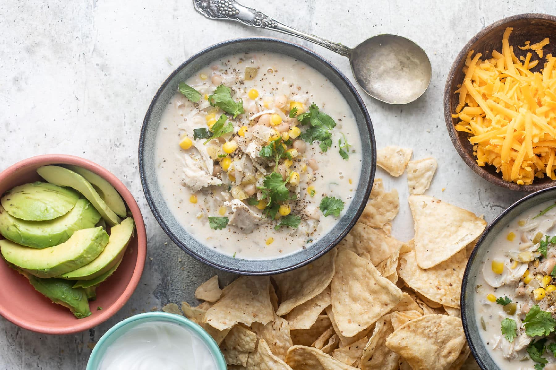Slow cooker white turkey chili in a blue bowl.
