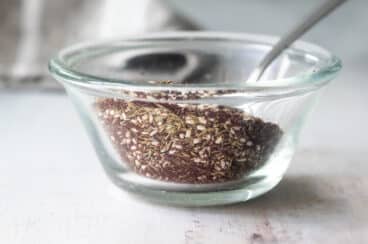 Za'atar seasoning in a clear glass bowl.